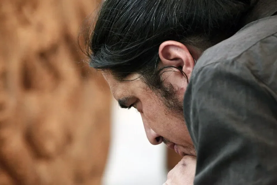 Close portrait of a Māori artisan concentrating on his work in New Zealand.