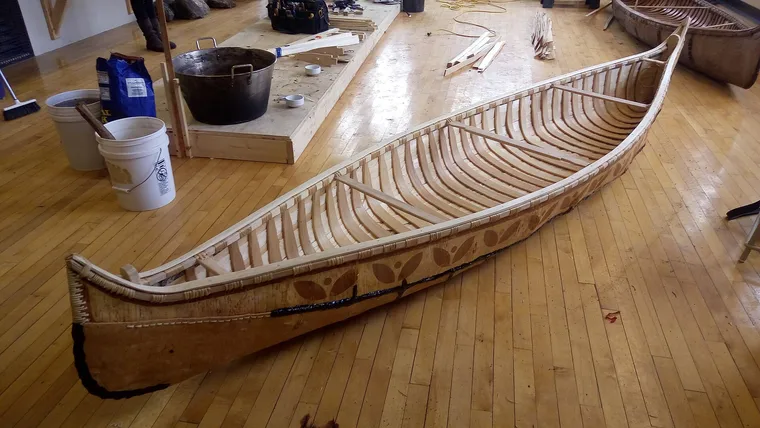 A photographed Anishinaabe birch-bark canoe; the image source identifies this particular canoe’s cultural context.