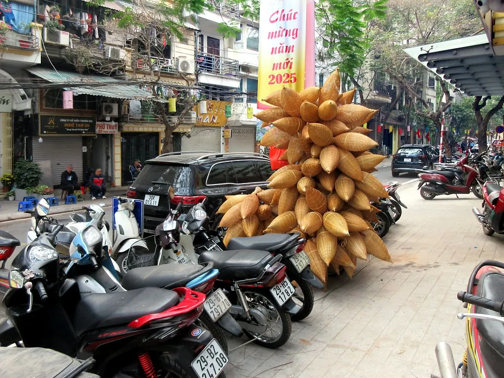 Handwoven bamboo fishing baskets stacked outside a shop in Hanoi, Vietnam.