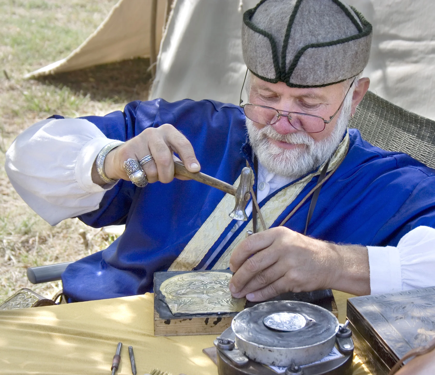 Techniques A traditional Hungarian metalworker uses a hammer and hand tool to shape an ornate metal plate near Makó.